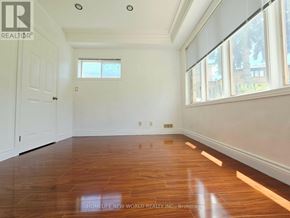 Toronto (Centennial Scarborough) apartment for rent - A room with wooden floors and white walls.