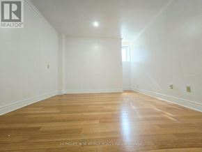 Toronto (Centennial Scarborough) apartment for rent - A room with wooden flooring and white walls, with a light source coming from the window.