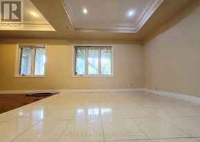 Toronto (Centennial Scarborough) apartment for rent - A spacious room with a large window and a tiled floor.