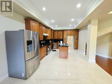 Toronto (Centennial Scarborough) apartment for rent - A kitchen with a refrigerator, cabinets, and a counter.
