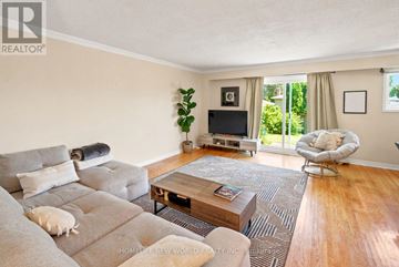 Mississauga (Cooksville) apartment for rent - A living room with a grey couch and a wooden coffee table.