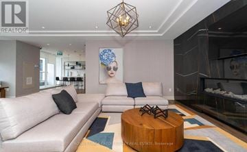 Hamilton (Beasley) condo for rent - A modern living room with a white sofa and a wooden coffee table.