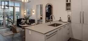 Burnaby apartment for rent - A modern kitchen with a large island and a view of the city.