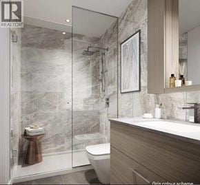 Burnaby apartment for rent - A modern bathroom with a marble wall and a wooden vanity.