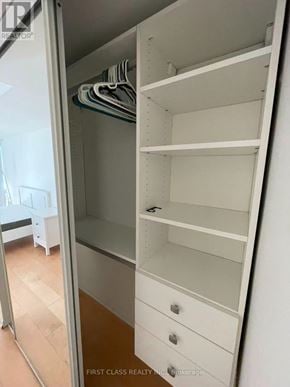 Toronto (Bay Street Corridor) condo for rent - A white closet with shelves and drawers is open.