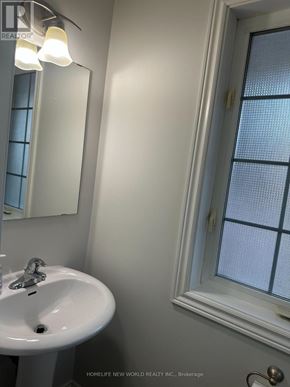 Whitby (Taunton North) townhouse for rent - A white sink under a mirror in a bathroom.