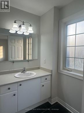 Whitby (Taunton North) townhouse for rent - A bathroom with a sink, mirror, and cabinet.