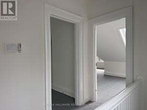 Toronto (North Riverdale) triplex for rent - A white door with a mirror on the wall.
