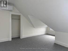 Toronto (North Riverdale) triplex for rent - A room with a carpeted floor and a window.