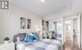Toronto (Bendale) condo for rent - A bedroom with a bed, nightstand, and bookshelves.
