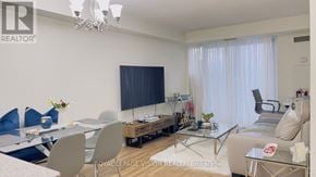 Toronto (Bendale) condo for rent - A living room with a glass table and a television on the wall.