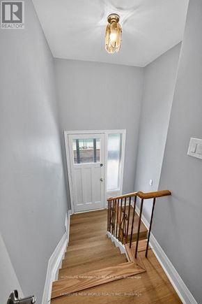 Toronto (Bathurst Manor) apartment for rent - A hallway with a wooden floor and a white door.