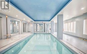 Toronto (Wexford-Maryvale) condo for rent - A large indoor swimming pool with a blue ceiling and white walls.