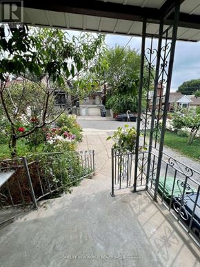 Toronto (Keelesdale-Eglinton West) apartment for rent - A view from a balcony looking down at a green car and a house.