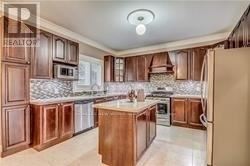 Toronto (Highland Creek) apartment for rent - A kitchen with wooden cabinets and a central island.