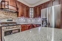 Toronto (Highland Creek) apartment for rent - A kitchen with a granite countertop and stainless steel appliances.