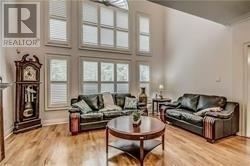 Toronto (Highland Creek) apartment for rent - A living room with a couch, a coffee table, and a grandfather clock.