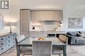 Mississauga (Port Credit) condo for rent - A modern kitchen with a glass table and grey chairs.