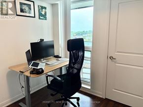 Toronto (Willowdale East) condo for rent - A black office chair is in front of a desk with a computer monitor, keyboard, and mouse.