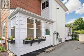 Mississauga (Clarkson) apartment for rent - A white house with a brick wall behind it.