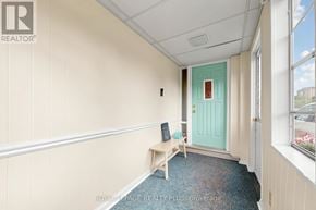 Mississauga (Clarkson) apartment for rent - A room with a bench and a door.