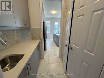 Markham (Middlefield) townhouse for rent - A kitchen with a sink and a door.