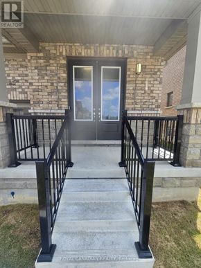 North Dumfries apartment for rent - The entrance to a building with a glass door and a metal railing.