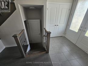 North Dumfries apartment for rent - A staircase with a wooden handrail leads to a white door.