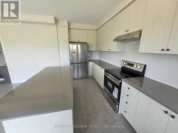 North Dumfries apartment for rent - A kitchen with white cabinets and a black countertop.