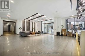 Toronto (Niagara) condo for rent - A spacious office lobby with a reception desk and a seating area.