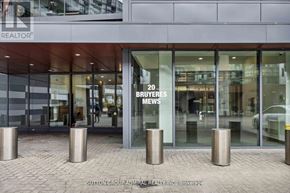 Toronto (Niagara) condo for rent - A building with a glass entrance and a sign that says "20 BUYERS NEWS".
