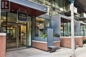 Toronto (Niagara) condo for rent - The front of a building with a glass door and a sign that says "The Yards".
