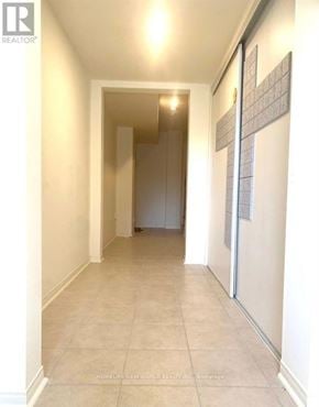 Richmond Hill townhouse for rent - A hallway with a tiled floor and a cross on the wall.