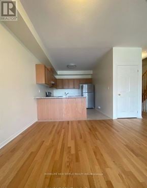Richmond Hill townhouse for rent - A kitchen with wooden floors and white walls.