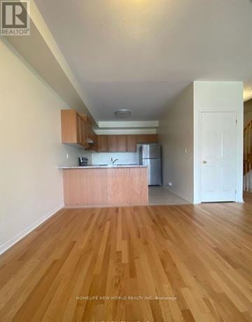 Richmond Hill townhouse for rent - A kitchen with wooden floors and white walls.