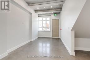 Toronto (Keelesdale-Eglinton West) multi-family for rent - A large, empty room with a door and a window.