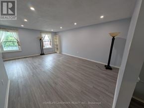 Toronto (Tam O'shanter-Sullivan) apartment for rent - A spacious room with wooden flooring and white walls.