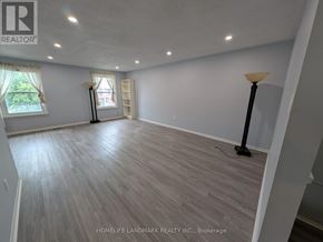 Toronto (Tam O'shanter-Sullivan) apartment for rent - A spacious room with wooden flooring and white walls.