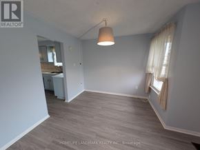 Toronto (Tam O'shanter-Sullivan) apartment for rent - A room with a grey floor and a white ceiling with a light hanging from it.