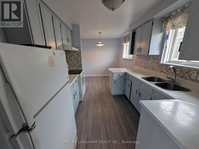 Toronto (Tam O'shanter-Sullivan) apartment for rent - A kitchen with a white fridge and wooden floors.