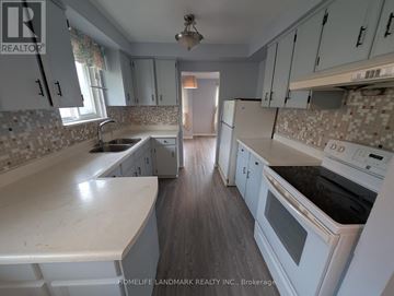 Toronto (Tam O'shanter-Sullivan) apartment for rent - A kitchen with white cabinets and a tiled backsplash.
