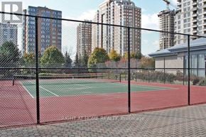 Mississauga (City Centre) condo for rent - A tennis court is enclosed by a black fence.