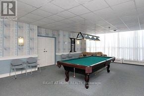 Mississauga (City Centre) condo for rent - A pool table in a room with a light blue wallpaper.