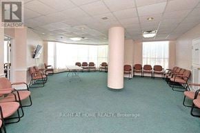 Mississauga (City Centre) condo for rent - A room with chairs and a pillar with a logo on the top left.