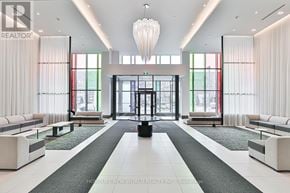 Markham (Commerce Valley) condo for rent - A large, modern lobby with a black and white color scheme.