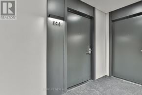 Markham (Commerce Valley) condo for rent - A hallway with doors numbered 306 and 307.