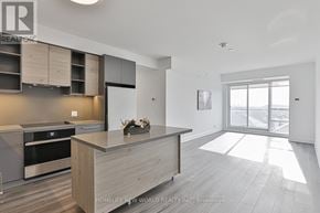Markham (Commerce Valley) condo for rent - A modern kitchen with a large island and stainless steel appliances.