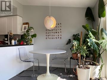 Ottawa townhouse for rent - A white table with chairs and a hanging light fixture in a kitchen.