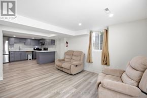 Ajax (Central West) apartment for rent - A living room with a beige couch and a matching chair.