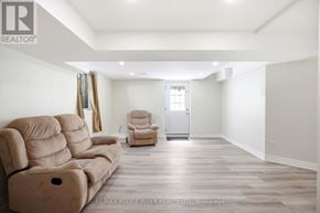 Ajax (Central West) apartment for rent - A spacious living room with a beige sofa and armchair.